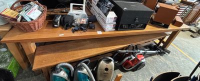 a wooden table with a bunch of electronics on it
