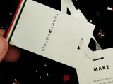a person holding a tag that says make a wish on it