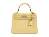a yellow leather handbag on a white background