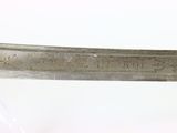 a knife with writing on it sitting on a table