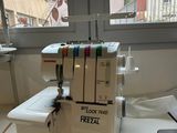 a sewing machine sitting on a table in front of a window
