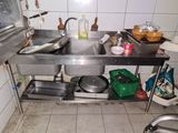a kitchen with a sink, stove, and other items on the counter