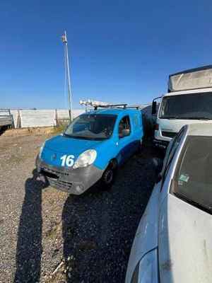 a blue van that is parked next to a white van