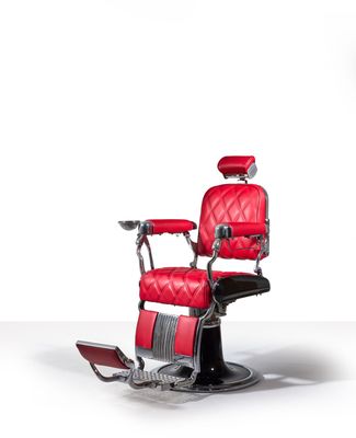 an image of a red barber chair on a white background