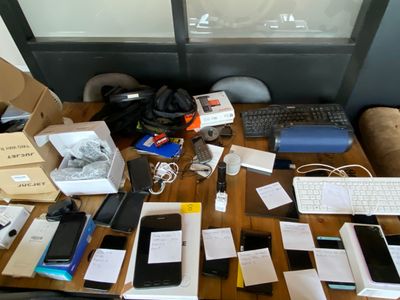many electronic devices on a table with boxes on it