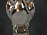 a silver vase that is sitting on a table