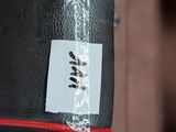a black bag with a sticker on it hanging from a hook