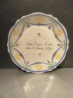 a plate with a quote on it sitting on a table
