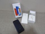 a box with a phone and a charger in it