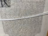 an old book with writing on it sitting on a table