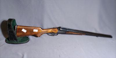 a rifle with a wooden handle and a green hat on a white background