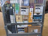 a metal cart with many items in it in a warehouse