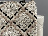 the white purse has a black and white design on it