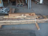 several pieces of wood are stacked on top of each other in a warehouse