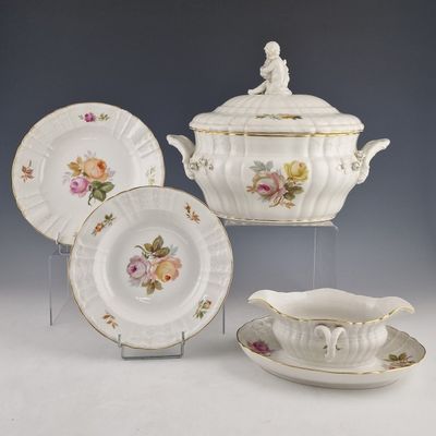 three pieces of china on display on a table