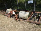 two cement mixers sitting on the ground next to a fence
