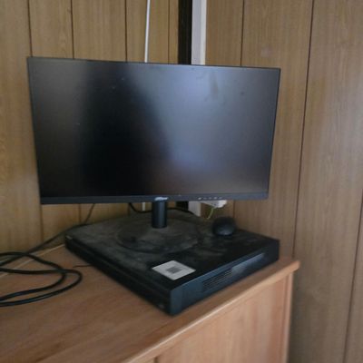 a flat screen tv sitting on top of a wooden cabinet
