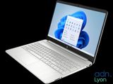the laptop is open on a black background with a blue background