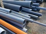 pipes and pipes are stacked up in a pile on the ground