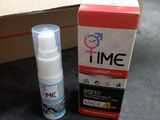 a bottle of time and a box on a table