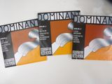 three different types of violin strings on a white surface