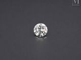 a round brilliantly cut diamond on a black surface