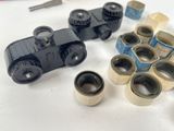 many rolls of tape on the table next to a pair of binoculars
