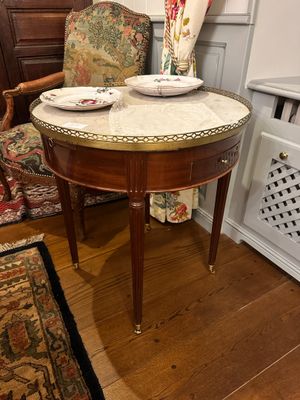 a small table with two plates on it in the corner of a room