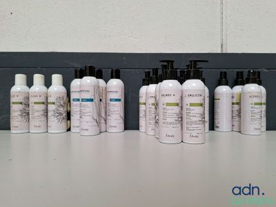 de nombreux flacons de différents types de produits capillaires posés sur une table