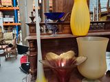 many vases sitting on a shelf in a store