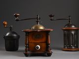 three different types of coffee grinders on a grey background
