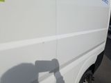 a white van parked in a parking lot with a yellow sticker on the side of the van