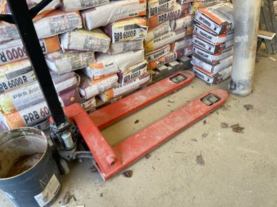 a pallet that is sitting in front of a pile of cement