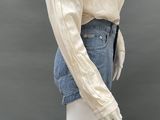 an image of a mannequin mannequin wearing a white blouse and denim shorts