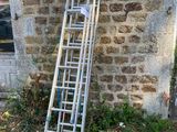 a ladder leaning against a brick wall next to a window