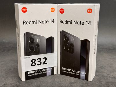 two boxes of redmi note 14 and redmi note 14 on a table