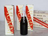 two boxes of champagne and a bottle of champagne sitting on a table