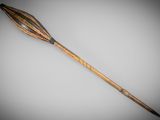 an old wooden stick with a long handle on a gray background
