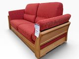 a red couch with a wooden frame and red cushions
