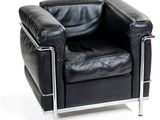 a black leather chair with chrome legs and a black leather seat