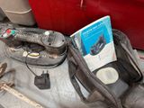 a bag with a remote control and a book on it