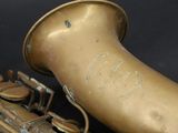 a saxophone that is sitting on a black surface