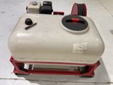 a white tank with a red handle sitting on a red cart