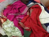 a pile of clothes in a basket on the floor