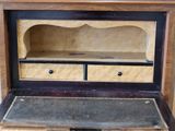 a wooden desk with a drawer on top of it