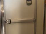a white refrigerator in the corner of a room with a door open