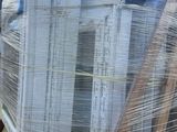 a large stack of boxes sitting on a pallet in front of a building