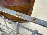 a close up of a metal gate with rust on it