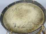 a drum with a rope around it on a white surface
