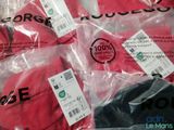 four red basketball balls wrapped in plastic bags on a table